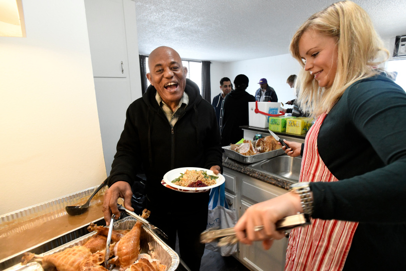 Taylor Equities serving Thanksgiving dinner to tenants